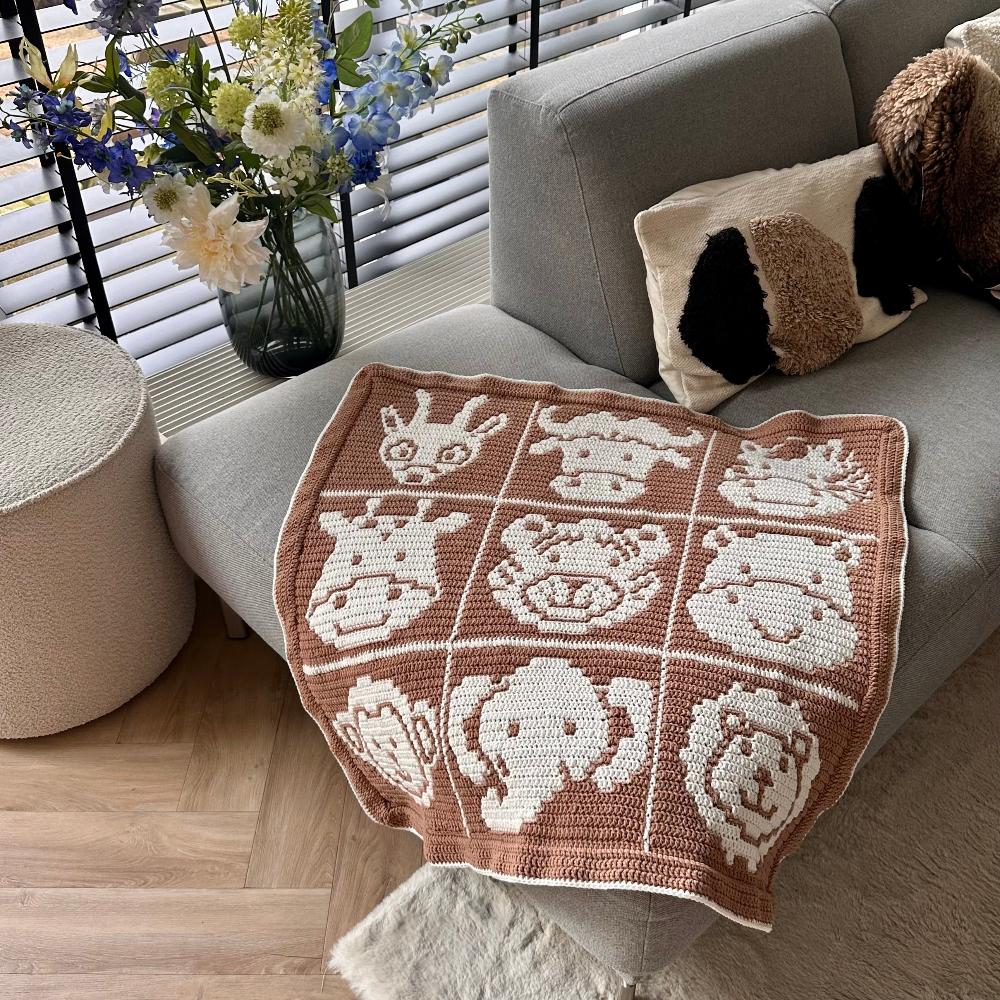 Overlay Mosaic Crochet Pattern - Safari Animals Baby Box Blanket on couch